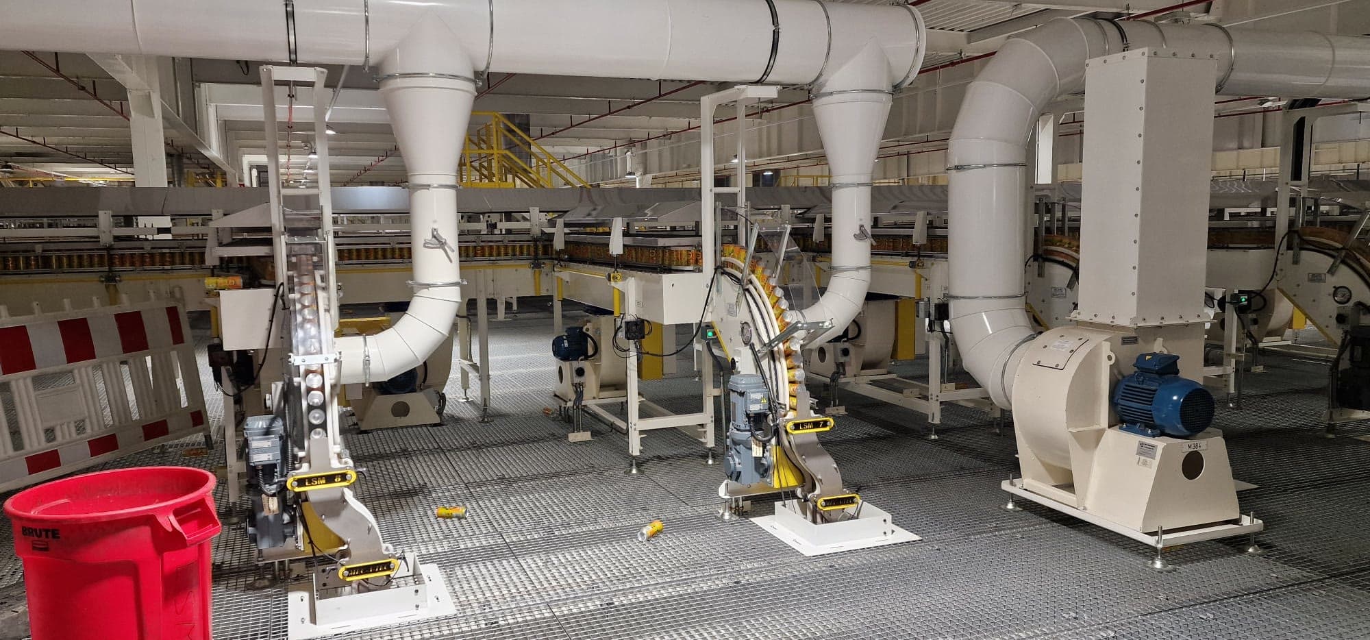 Cans running on overhead conveyors with elevators and extraction ducting