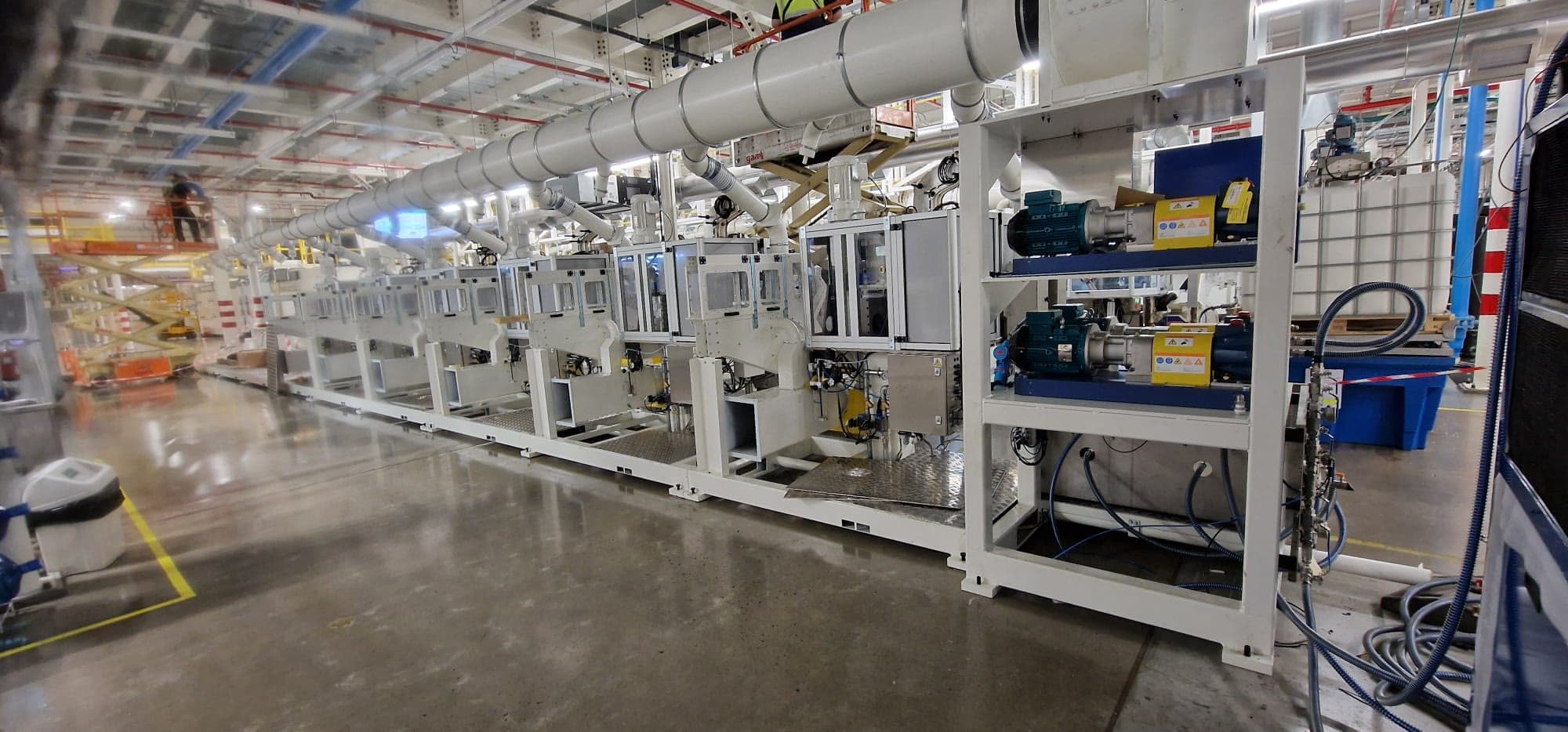 Coating line with extraction ducting and dosing pumps alongside