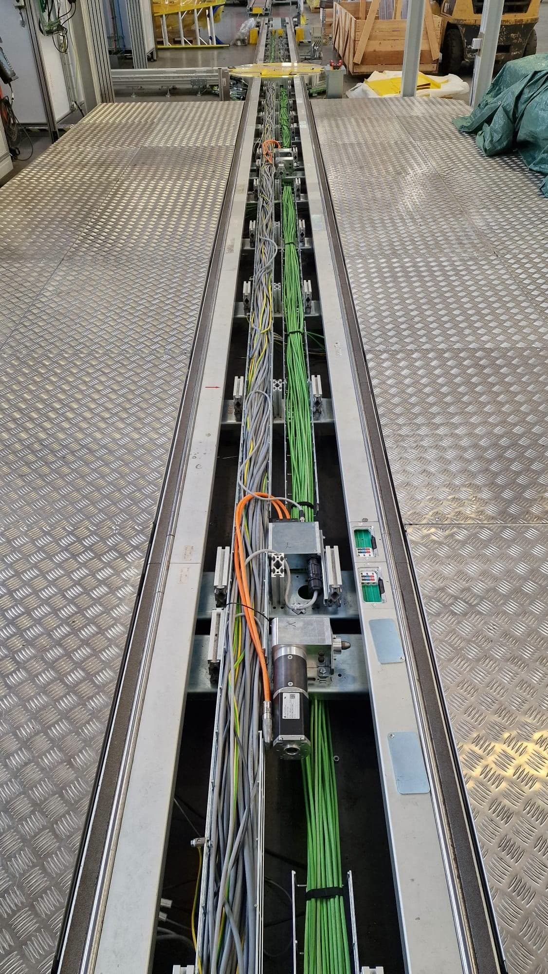 Floor channel carrying motor and network cabling along an assembly line
