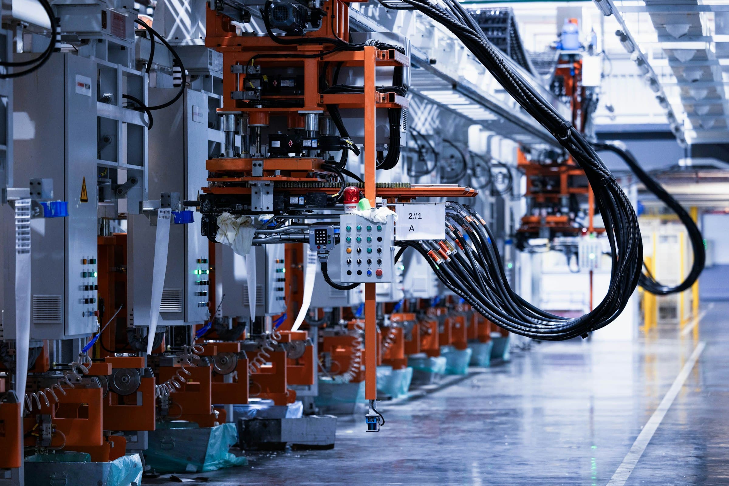 Row of electrical equipment down a production line inside a working factory